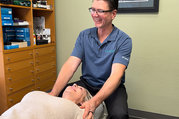 Dr Greg Olsen best Lake Forest chiropractor. Dr. Olsen preparing a patient for a cranial facial release, CFR, which can help treat vertigo/dizziness, breathing issues, sleep issues, facial pain, concussion, and cranial nerve issues.